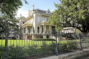 Featuring a lush garden and a historical home featured on the tour of the New Orleans Garden District.