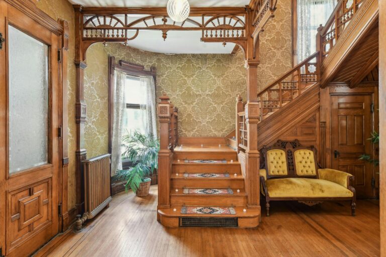 Elegant main staircase of the Harry F. Legg House featuring intricate woodwork and a classic banister, showcasing the home's historic charm.