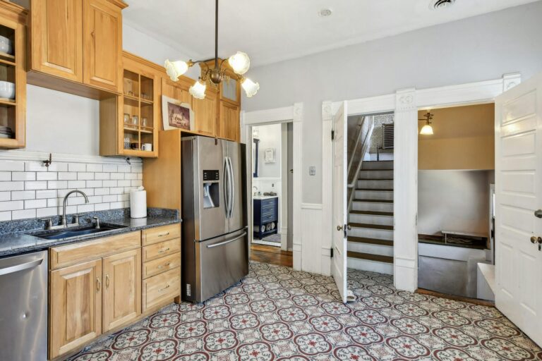 pacious kitchen in the Harry F. Legg House, blending modern appliances with traditional design elements, including ornate cabinetry and a cozy layout.