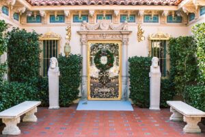 The ornate facade of Casa Grande at Hearst Castle, showcasing Mediterranean-style towers and intricate architectural details.
