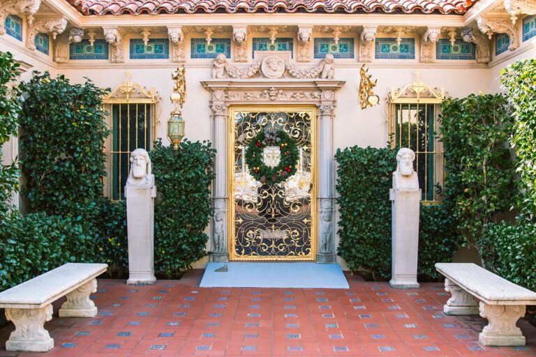 The ornate facade of Casa Grande at Hearst Castle, showcasing Mediterranean-style towers and intricate architectural details.