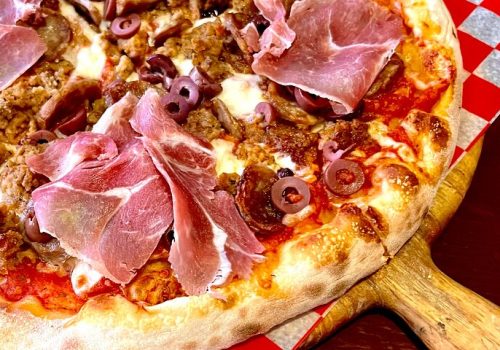 One of the best things to do as a tourist in New York city is a walking tour involving food! Pictured here is a meat lover's pizza fresh from a New York pizzeria.